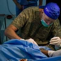Cmdr. Sandra Halterman and Hospital Corpsman 2nd Class Adam J. Smolski  prepare a patient for dental surgery aboard USS George H.W. Bush (CVN 77). 