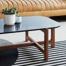 The plank dining table is a minimalist and sophisticated dining table with horizontal grooved legs and a warm walnut wood grain. Gus Modern Tables
