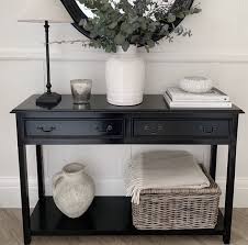 The media console has two adjustable shelves with double hourglass glass doors, so remotes work even when closed. Black Console Table With Two Drawers Annie Mo S