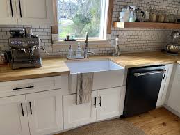 The combination of white kitchen cabinets with wood countertops is a beautiful effect that can be presented in a variety of different ways depending on the intensity and color of the stain that is used. Butcher Block Kitchen Wood Countertops Kitchen White Shaker Kitchen Cabinets Butcher Block Countertops Kitchen