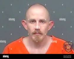 In this image provided by the Texarkana, Texas, Police Department, Aaron  Swenson is seen in his police booking photo. The 36-year-old Arkansas man  whose Facebook page included “boogaloo” references was arrested on