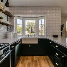 A sink under the window receives good natural light. Kitchen Bay Window Farmhouse Sink Design Ideas