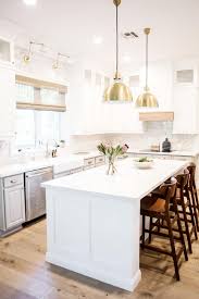 Looks great about dining room tables or living room areas. White Chef Kitchen With Gold Pendants Hgtv