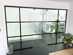 Choosing white doors with glass adds a contemporary look without compromising on style. Glass Partitions At Residential Project St Albans Hertfordshire Industrial Shoreditch Style Home Office Glass Sliding Door With Black Bars