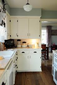 My kitchen has knotty pine cabinets and walls. How To Diy Paint Kitchen Cupboards Hit The Builder S Wife