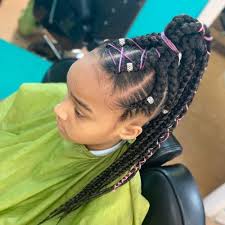 A cool design that has two separate braids on one side. The 11 Cutest Box Braids For Kids In 2021