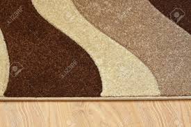 Laminat verlegen anleitung in 13 schritten obi laminat auf teppich?? Detail Der Teppich In Braun Beige Und Weiss Farben Auf Laminat Lizenzfreie Fotos Bilder Und Stock Fotografie Image 14476013