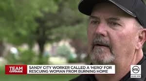 Sandy city worker called a 'hero' for rescuing woman from burning home