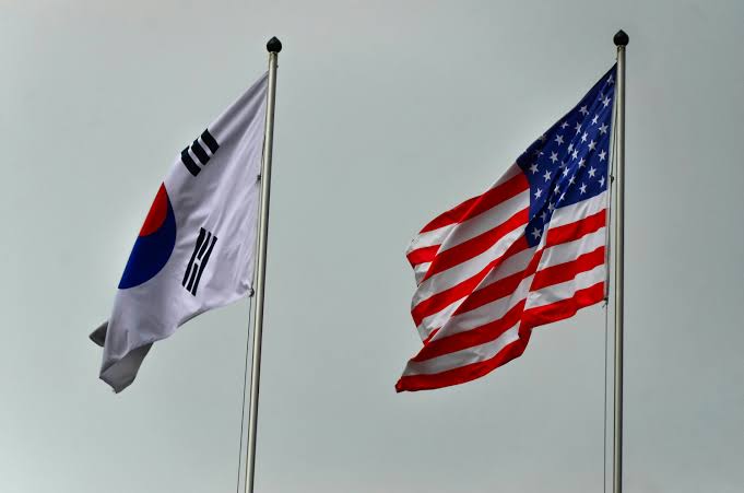 South korean and american flags flying - Free Photo on Unsplash