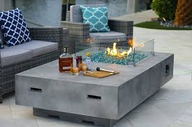 The fire pit converts into an outdoor table when not in use using a wooden topper. Rectangular Modern Concrete Gas Fire Pit Table In Gray Lowes Canyon Ridge W Glass Shield And Crystals Rec Gas Fire Pit Table Fire Pit Table Concrete Fire Pits