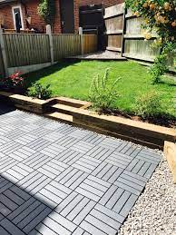 Our Diy Garden Using Wooden Railway Sleepers To Create Flower Beds And Ikea Runnen Decking For Flooring Patio Garden Floor Diy Garden Garden Landscape Design