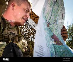 Sgt. 1st Class John Bradshaw with the Arkansas National Guard plots  coordinates during the call for fire event of the 2017 Army National Guard  Best Warrior Competition at Camp Ripley, July 19,