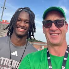 NC State QB CJ Bailey and Peyton Manning chillin during the Manning Passing  Academy. Just normal things.