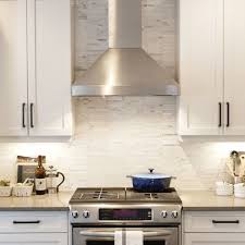 White Cabinets With Tile Marble Backsplash Stainless Steel Hood And Under Counter Lighting White Modern Kitchen