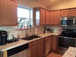 Laminate countertops with oak cabinets. The Feel Of A White Kitchen Without White Cabinets Builder Grade Oak Cabinets With High Resolution Laminate Oak Kitchen Oak Kitchen Cabinets Kitchen Remodel