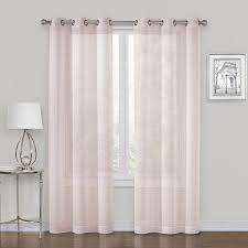 The lovely lurex fabric can be hung alone or paired with heavier grommet panels to brighten up any space. Whittier Blush Metallic Sheer Gromme Window Panel 84in At Home