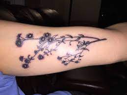Minimalist Tattoo Flowers In Black And Grey On Inner Upper Arm Minimalist Tattoo Tattoos Tattoos And Piercings