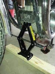 Homemade Motorcycle Front Lift Setup Consisting Of A Scissors Jack Arranged To Bear Against The Bike S Front Engi Homemade Motorcycle Homemade Tools Bike Stand