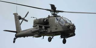 I saw chinook, blackhawk, and apache helicopters sprawled across the airfield, many of which were on the ground and being worked on, while a few periodically hovered above. Boeing Ah 64 Apache