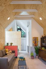 In Addition To Adding Several Windows To The Double Height Space Best Practice Also Used Light Plywood For The Interi House Backyard Garage Cozy Living Spaces
