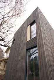 Vertical wood siding is hung up and down instead of horizontally like lap or clapboard siding. Knotty Cedar In Stained Ebony With Stainless Steel Nails Wood Siding Exterior Cedar Siding Vertical Wood Siding