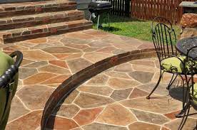 This is a stamped concrete patio and walkway with a small sitting flagstone wall. Color Shines In Prizewinning Stamped Concrete Project Concrete Decor