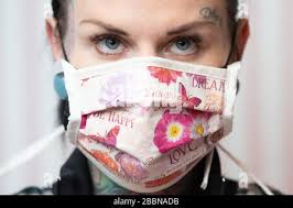 26 March 2020, Saxony, Zwickau: Daniela Beck, tattoo artist wears a  self-stitched mouth guard. Beck