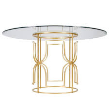 This transparent glass coffee table hoists a sleek airy design and provides a clean, uncluttered vibe in your space. Worlds Away Jennifer Gold Leaf Dining Table I Layla Grayce