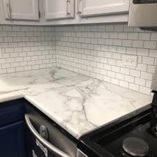 White hexagon penny tiles with white grout bring in texture and geometry wthout standing out too much. White Peel And Stick Tile With Gray Grout 12x12inch Clever Mosaics