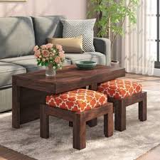 Find a coffee table that echoes the rich tones and elegant style of your current decor, and pair it with a few matching end tables to create a cohesive look. Kivaha 2 Seater Coffee Table Set Urban Ladder