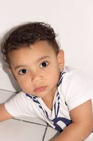 A young boy in a white shirt and blue tie. Child happiness joy.