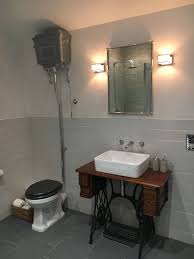 Old Singer Sewing Machine Used As A Vanity Table High Level Toilet Cistern With Images Cheap Bathrooms Singer Sewing Machine Table Bathroom Vanity Units