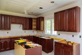 Once the veneer is set in place, then use a roller to ensure a strong bond and without any type of continue to apply the cement and veneer until you have completed the entire kitchen cabinet. Refinishing Veneer Kitchen Cabinets