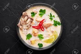 Tom kha gai is seasoned primarily with lime juice and fish sauce. Tom Kha Gai Or Thai Coconut Chicken Soup In Black Bowl On Dark Slate Background Tom