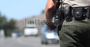 A Police Officer Standing By Traffic Police Traffic Lawyer Criminal Justice