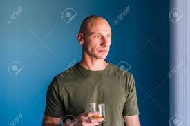 A celebration of brandy's best braid moments. Portrait Of Young Handsome Man With Short Hair Holding A Glass Of Whiskey Or Brandy Alcohol Drink Standing In Front Of Blue Wall Looking Trough The Window Stock Photo Picture And Royalty