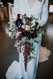 Check the post for bridal bouquet photos! Trailing Winter Bridal Bouquet Bride In Lace Wed2b Bridal Gown Copper Greenery Winter Bridal Bouquets Wedding Flower Arrangements Winter Wedding Bouquet