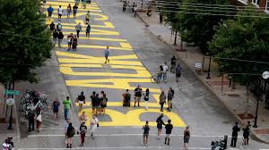 Children pose for a photo in front of a mural marking black wall street, also called the greenwood distric, june 18, 2020 in tulsa, oklahoma. A Black Lives Matter Mural On Tulsa S Black Wall Street Is Being Removed After City Officials Said It Was Never Approved Cnn