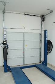 There are two brass contacts in the light bulb socket of a garage door opener. High Lift Garage Door Conversion