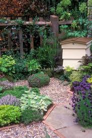 Keeping Bees In Hive In Herb Garden With Garden Path And Fence Planting Flowers Garden Paths Plants
