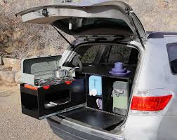 It is a three part assembly with a cabinet door, slide out table, under storage and a sleeping area. Toyota Highlander Camper Conversion