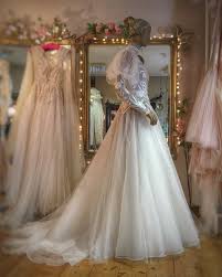 A structured bodice is embellished with beaded flowers, and there. Helianthus Wedding Dress By Joanne Fleming High Neck Long Sleeve Wedding Dress Wedding Dresses Wedding Dress Long Sleeve