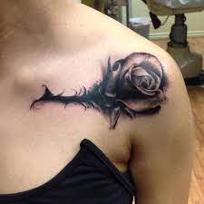 Rose with quotations in which an alarm watch is a place in the center. Artistic Black Rose Tattoo On Girl Shoulder