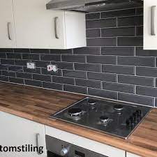 In turn, the narrow space seems longer and more open. Marylebone Dark Grey Grey Kitchen Tiles Grey Kitchen Walls Black Tiles Kitchen