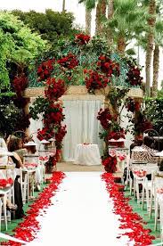 Tall cylindrical vases held a large arrangement of red roses at the top for the centerpieces. 50 Red Rose Wedding Ideas Perfect For Valentine S Day Weddingomania