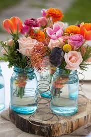 Country wedding flowers in mason jars. Mason Jar Wedding Flower Arrangements