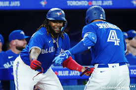 Toronto Blue Jays right fielder George Springer (4) celebrates his solo home run against the Detroit Tigers with teammate Vladimir Guerrero Jr. (27) during fifth inning MLB American League baseball action in