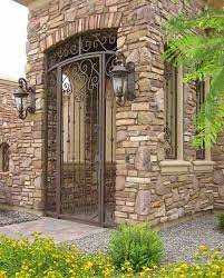 The front gate should be made of quality material since it is classically an accent to the home frontage and it complement the landscaping. Wrought Iron Gates Courtyard Gate Design Wrought Iron Entry Gate Driveway Gates Inland Empire Corona Riverside Eastvale Lake Elsinore Elite Landscape Concrete