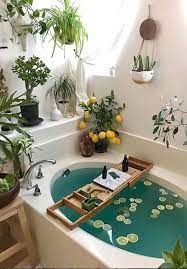 Position a small standing shelf or table near the side of the tub, or invest in a caddy—designer amy sklar will sometimes use a wood cheeseboard as a makeshift one. 69 Greenery And Flower Decor Ideas For Bathrooms Digsdigs