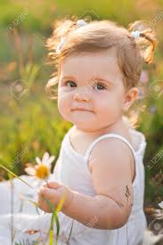 Large Sunny Portrait Of A Child With A Daisy Flower. Stock Photo, Picture  and Royalty Free Image. Image 198193132.